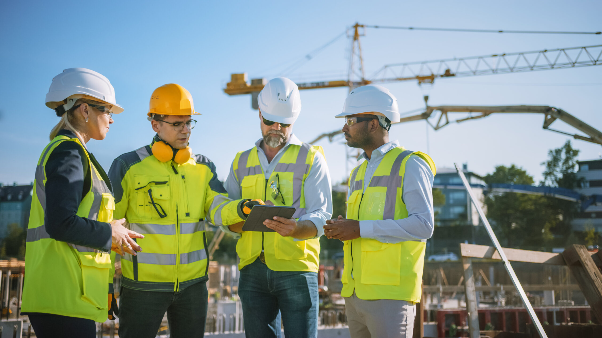 construction workers looking at management software on site