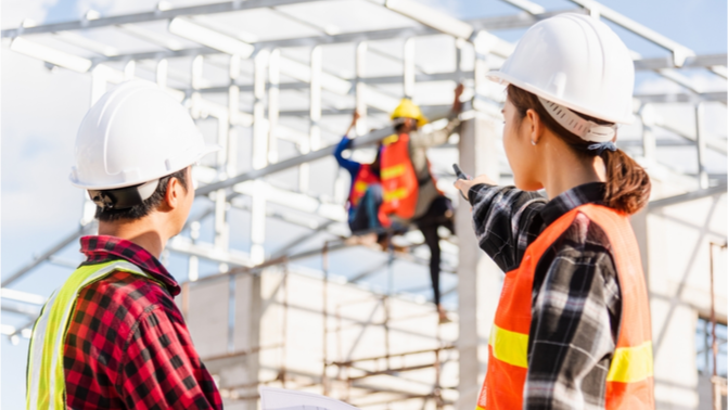 Women and men on large, complex construction site